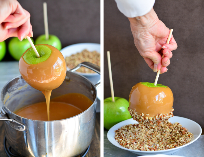 A green apple on a stick covered in caramel that is dripping back into a pot of caramel.
