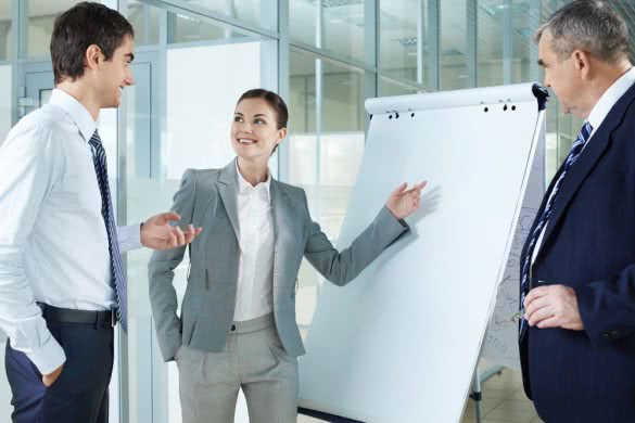 Young woman presenting project to her colleagues